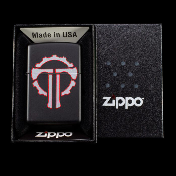 Black Zippo lighter with a gear design, presented in a branded box, highlighting its Made in USA quality.