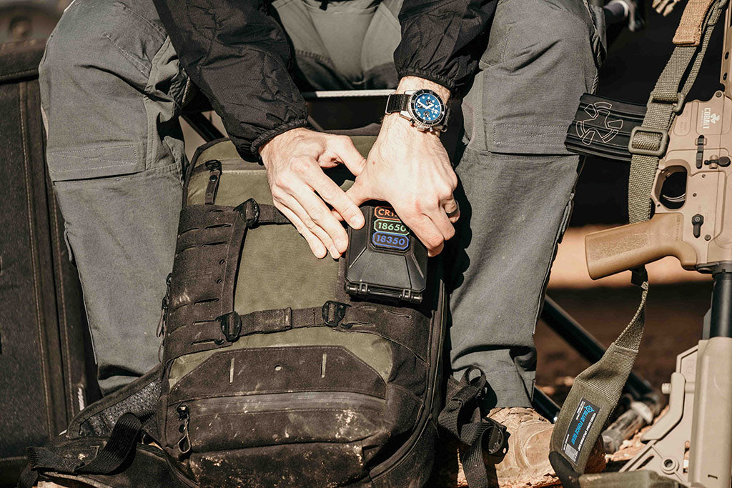 Person opening a CellVault-5M Modular Battery Storage Case that is attached to a backpack