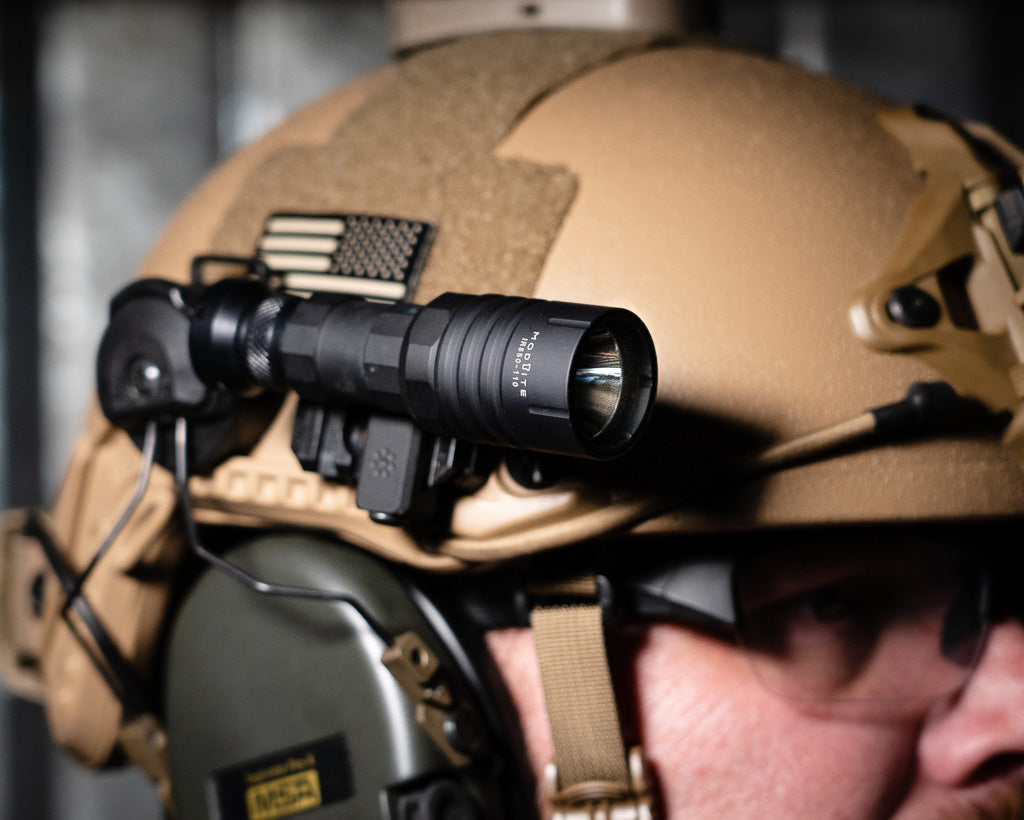 Modlite light mounted to a Thyrm VariArc on a coyote tan helmet.