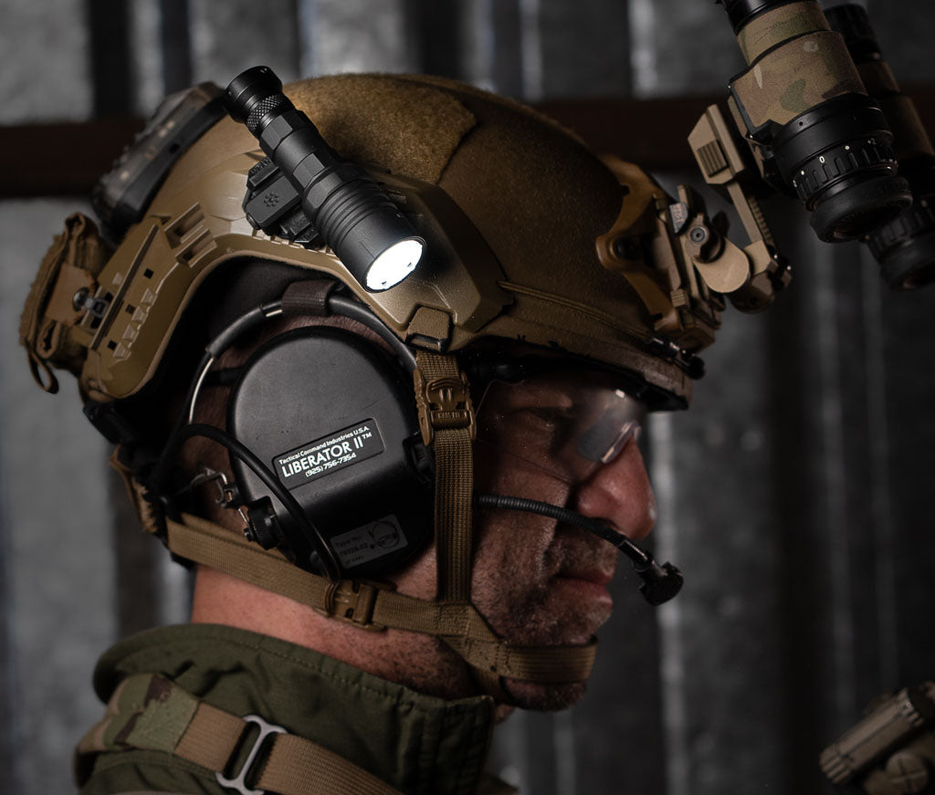 Person wearing a tactical helmet with communication equipment, Thyrm VariArc with light, and NODs.