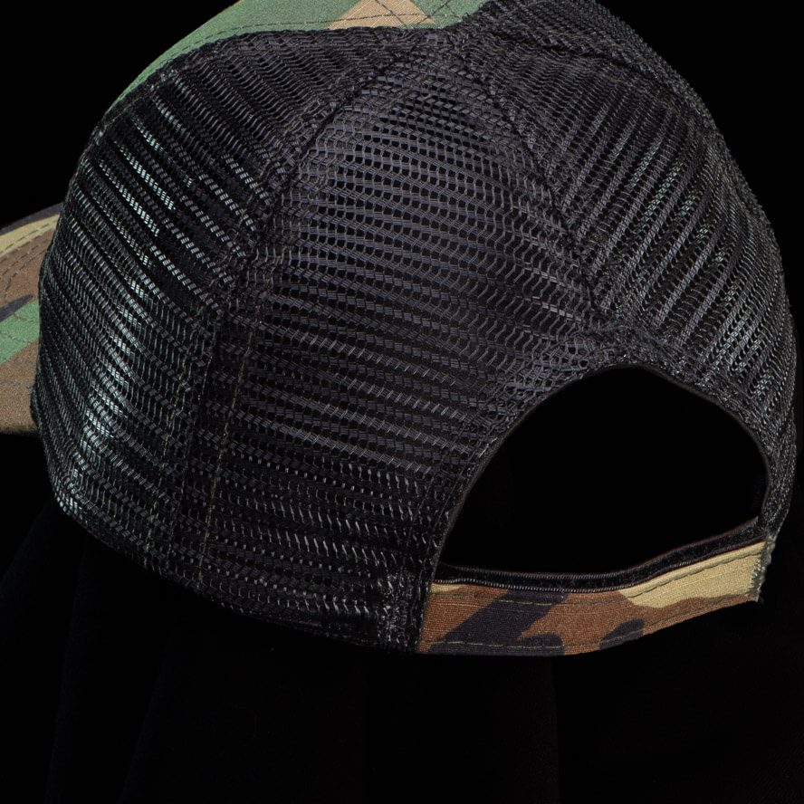 Thyrm camouflage trucker hat featuring a breathable mesh back and adjustable Velcro closure for comfort and fit.