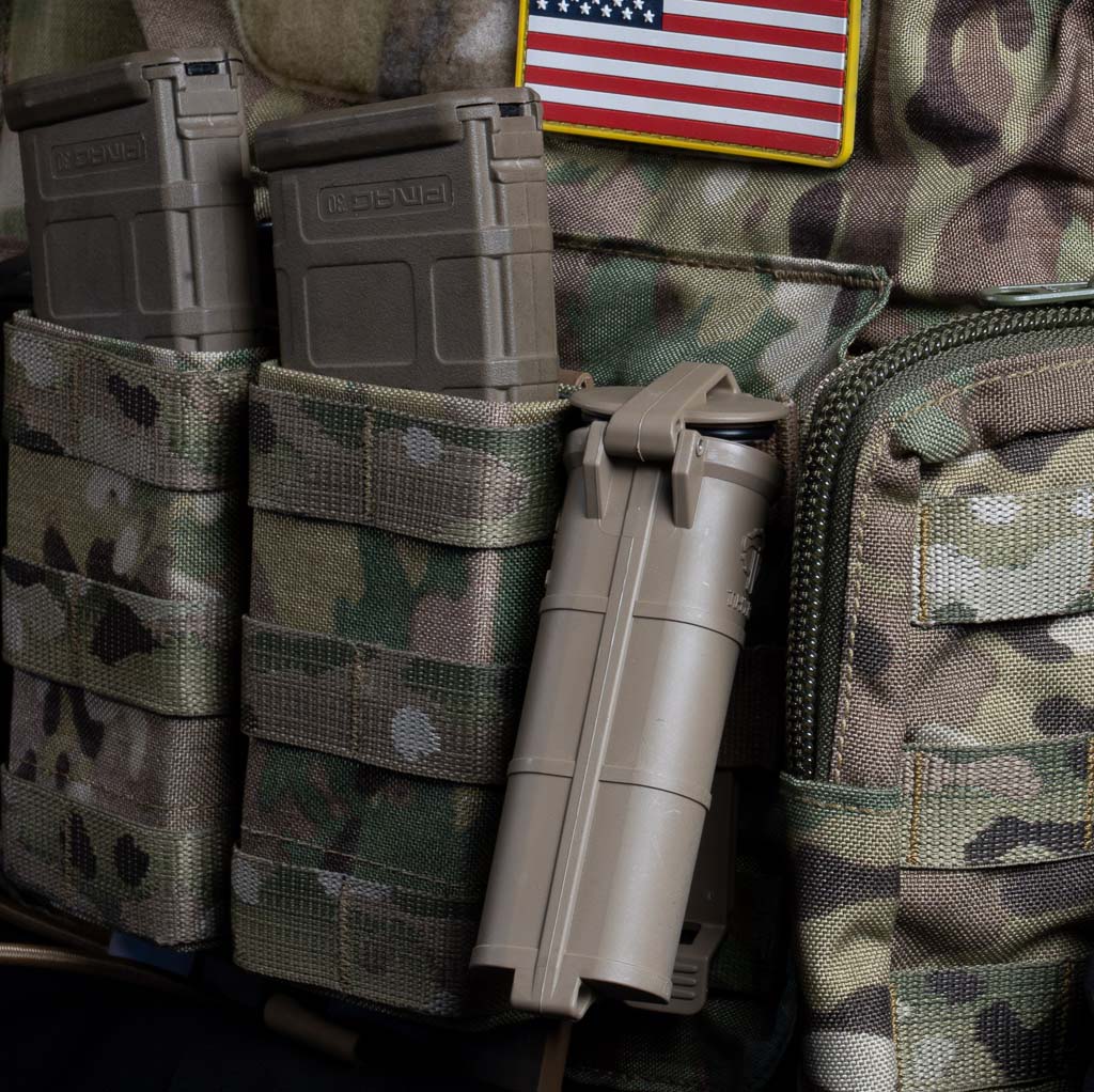 CellVault XL in FDE opening while still mounted on MOLLE amongst other gear.