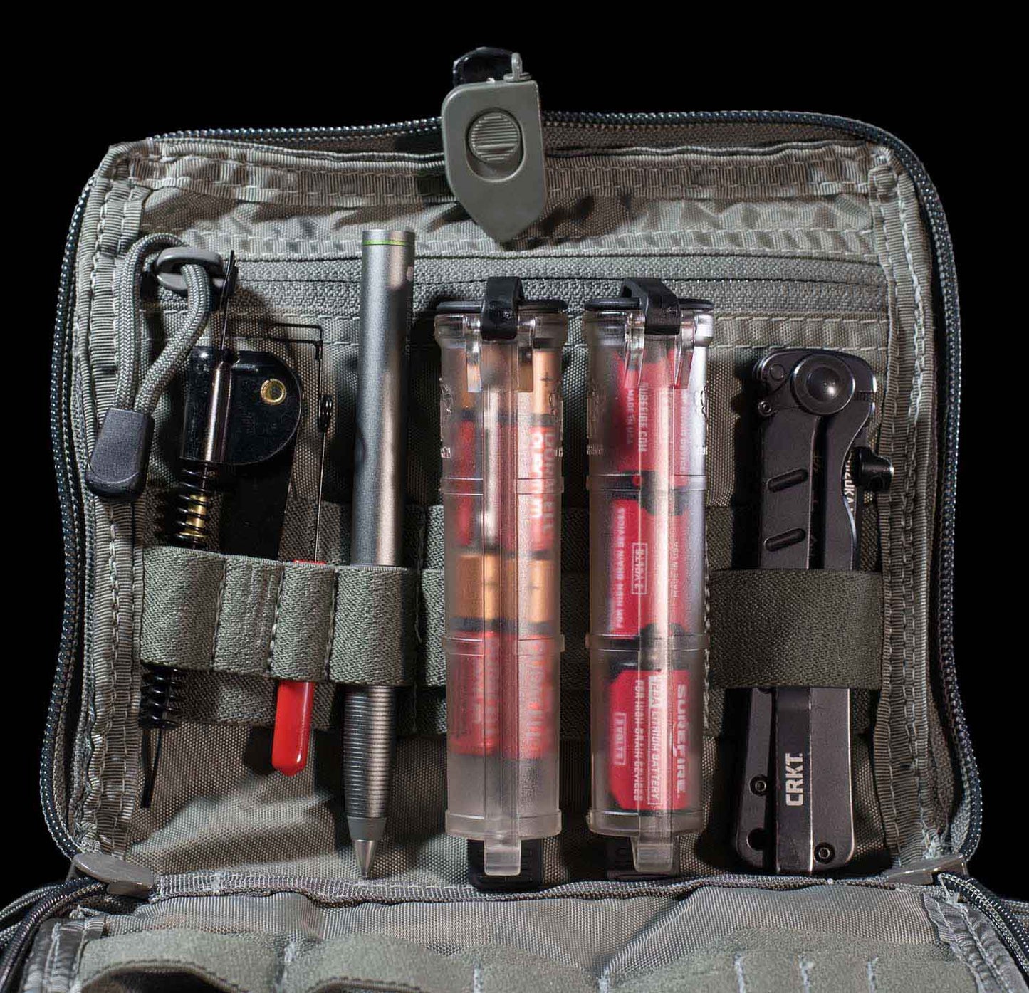 Two Clear CellVault battery storage cases, original size, with compartments for AAA and CR123 batteries, tools, and accessories organized inside.