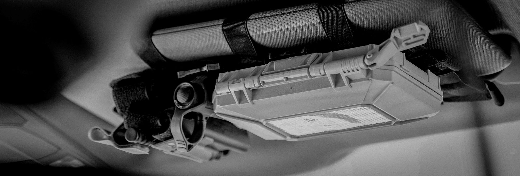 Black and white photo of Thyrm Darkvault attached to a vehicle's visor