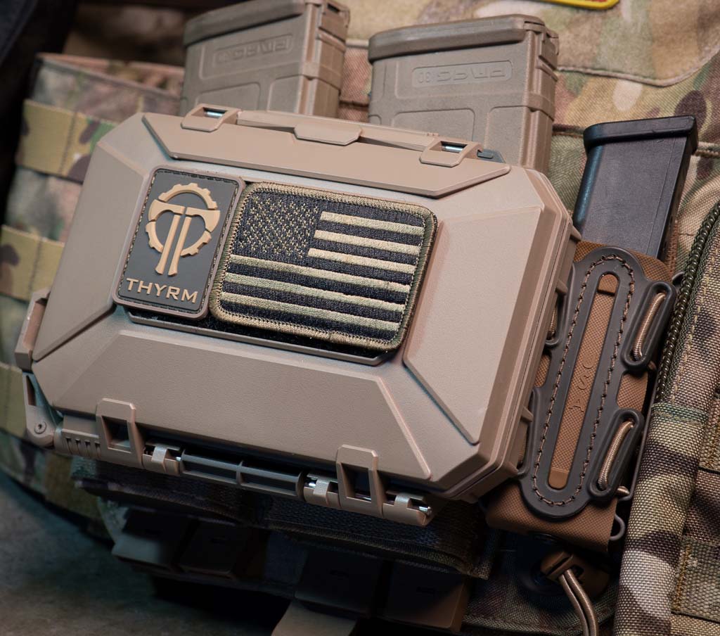 DarkVault Comms Critical Gear Case (original model) in FDE with patches marking the exterior Velcro