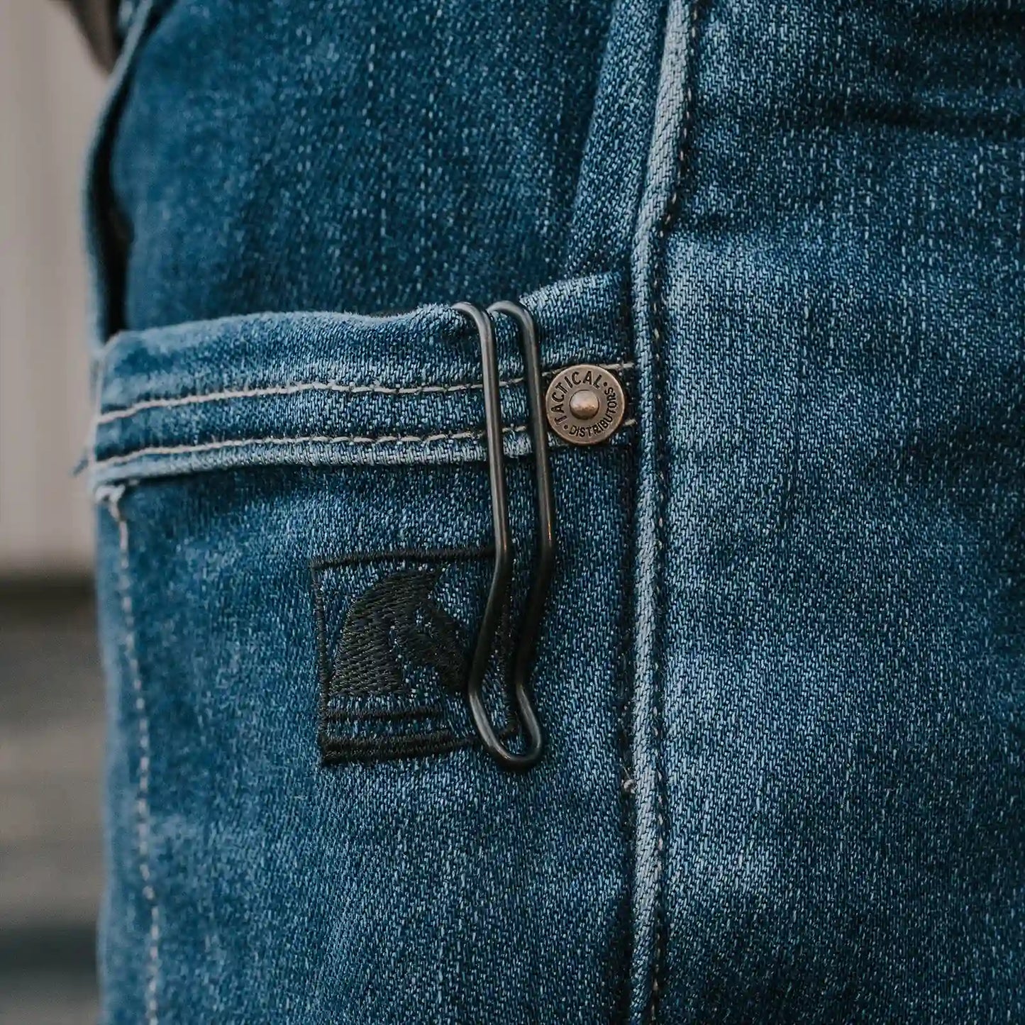 Close-up of Tactical Distributors blue jeans with a Thyrm Deep Carry Pocket Clip. 