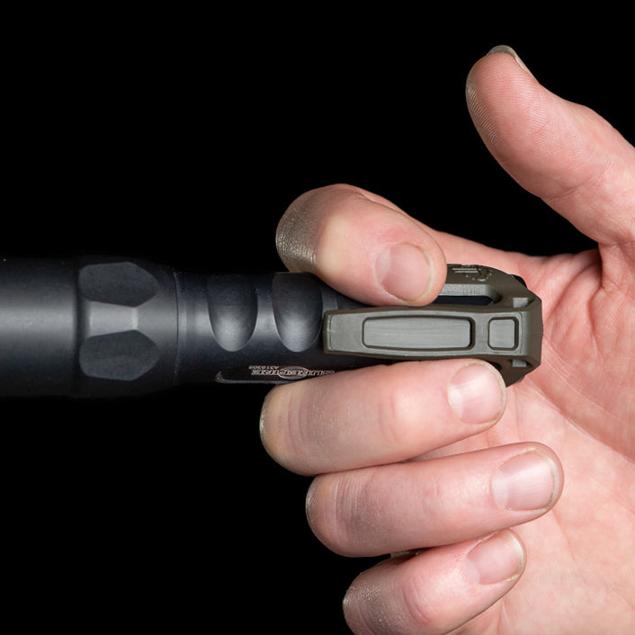 Low profile carry flashlight pocket clip shown in a hand, highlighting its compact design and easy accessibility.
