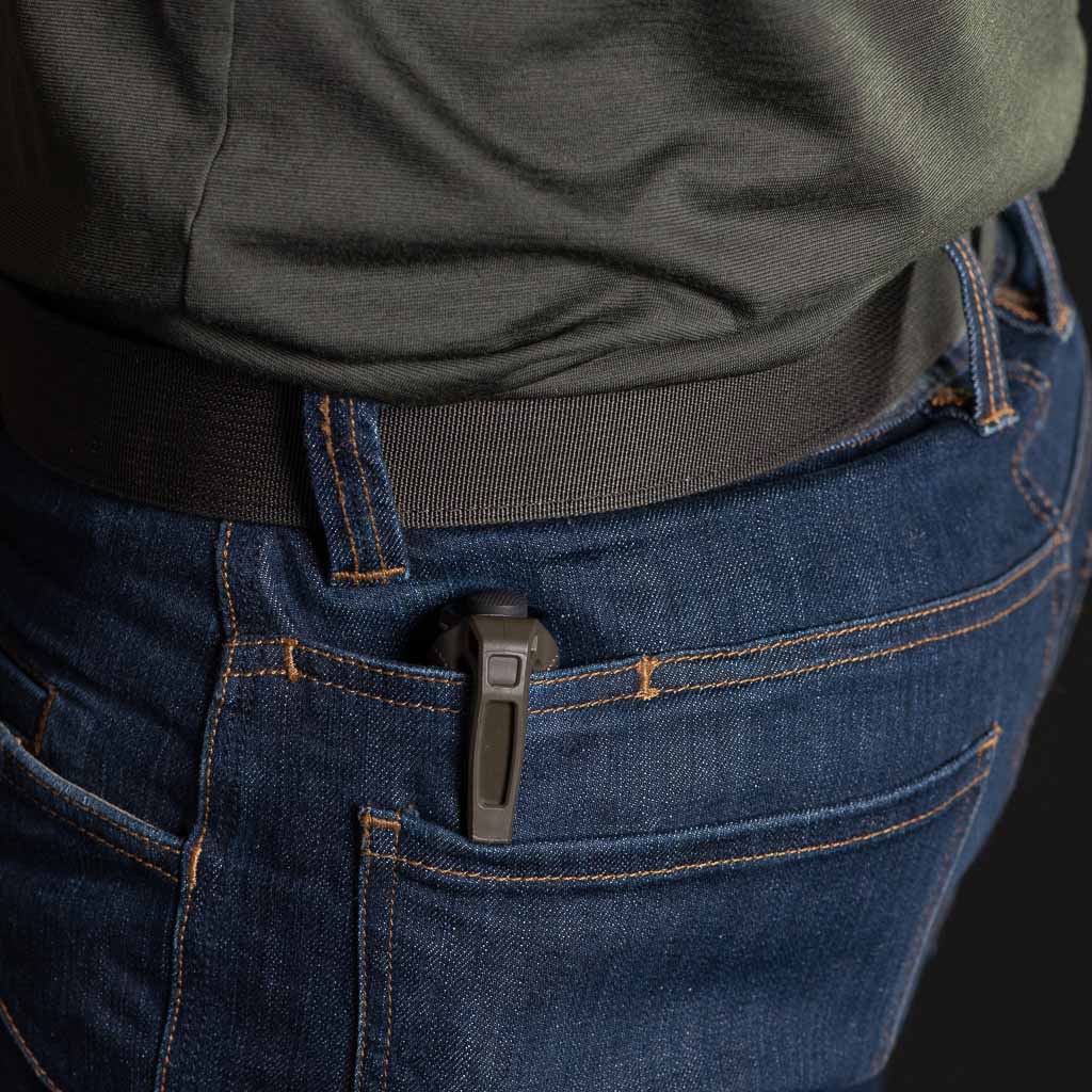 Close-up of a person wearing blue jeans with a flashlight with a Thyrm LPC Clip in the pocket.