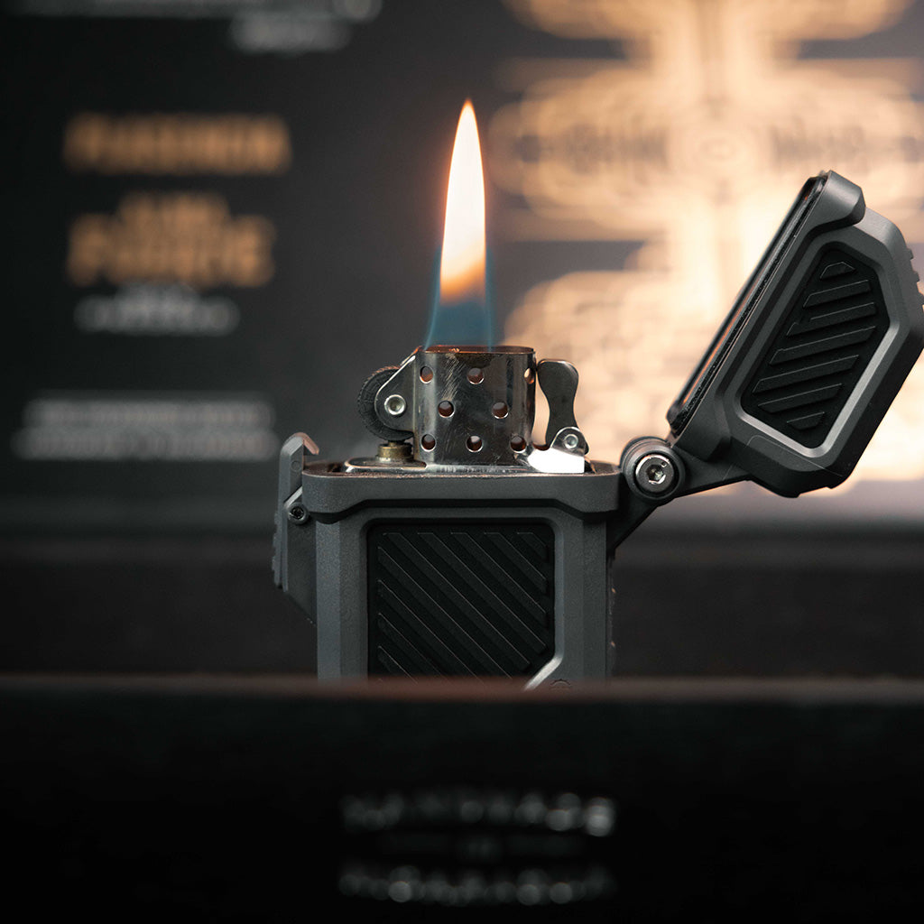 Close-up of a zippo lighter in a Thyrm PyroVault against a blurred background