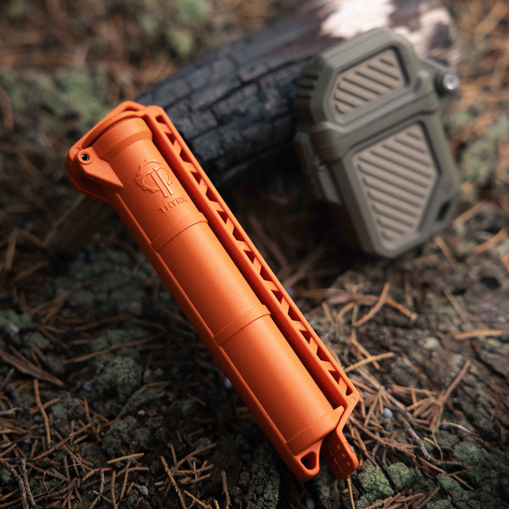 Orange CellVault and Olive Drab/FDE PyroVault 2.0 in the woods.