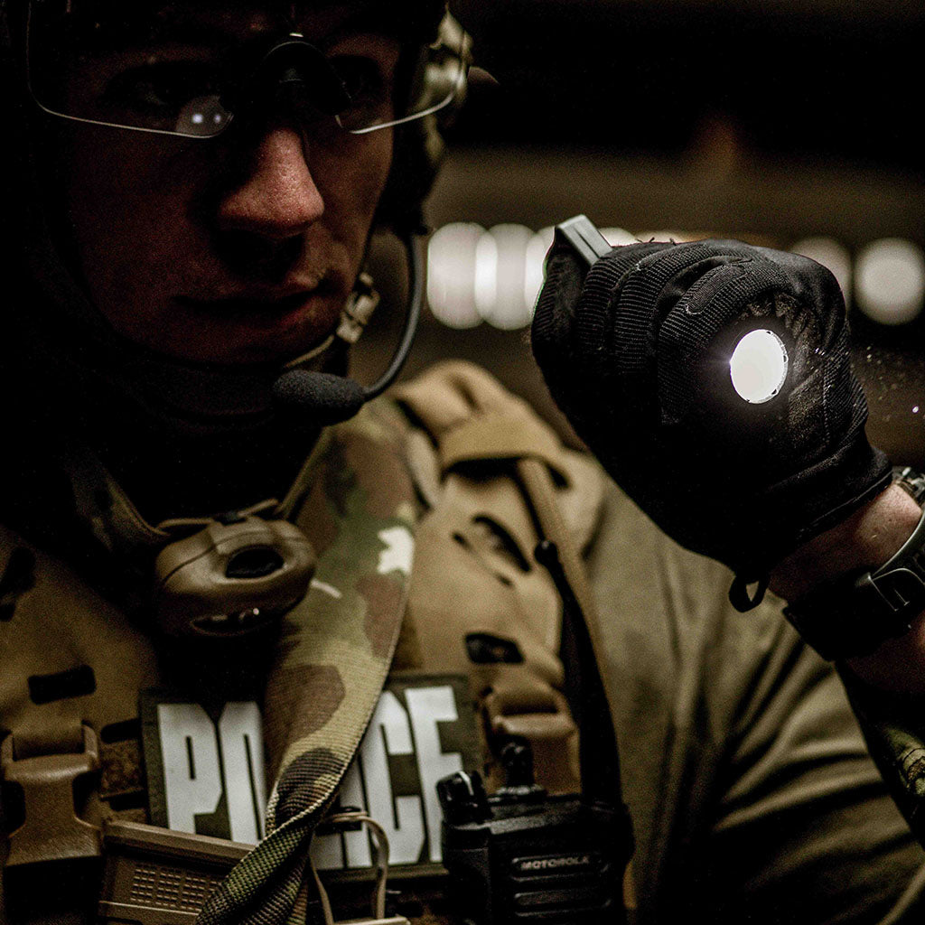 Policeman illuminating the night with a SwitchBack on a flashlight