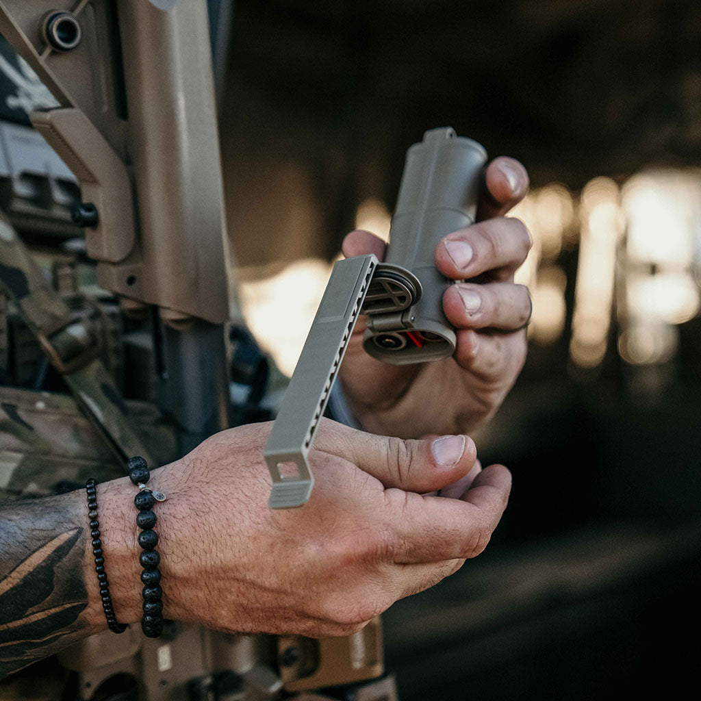 Person in tactical gear using a Thyrm Cellvault XL 