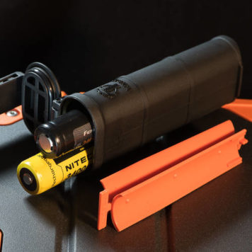 Two large flashlight-specific batteries emerging from a CellVault XL, with orange divider removed