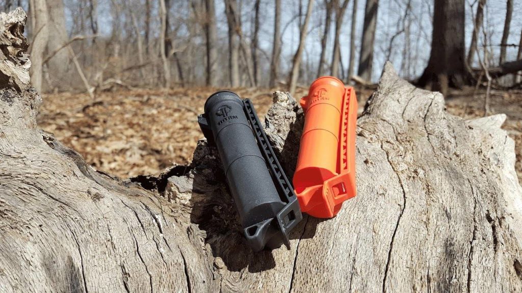Black and Orange CellVault XLs on a log, still shot from a video review from Coach Helder