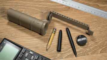 Opened CellVault XL showing its contents - a pencil, pen, and sharpener, alongside a calculator and ruler