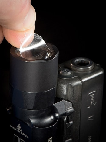 Main image of CLENS Lens Protectors, showing CLENS being applied to a mounted light
