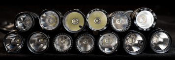 A collection of lenses on different flashlights, showing variation in size and texture