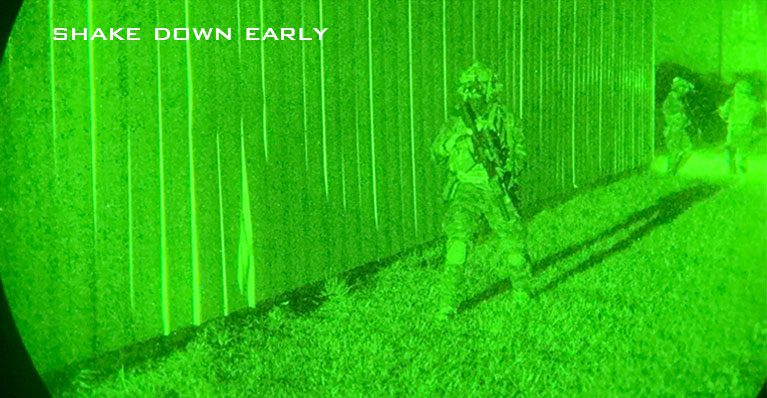 Night vision image of student walking with full kit